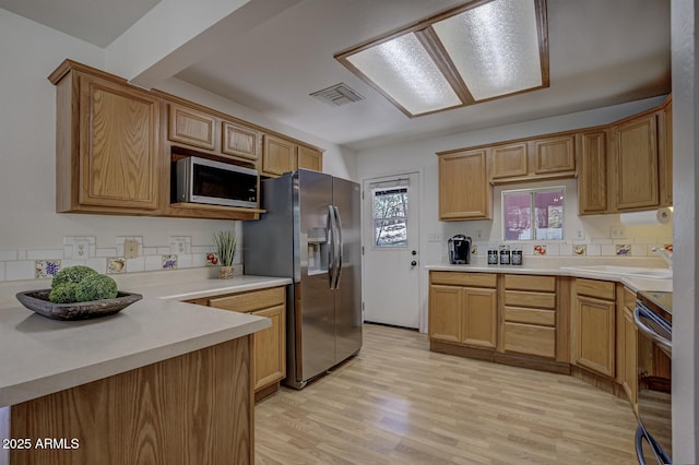 3440 N Meadow Dr, Pine, AZ 85544 - kitchen with stainless steel appliances, light wood-type flooring, a sink, and light countertops