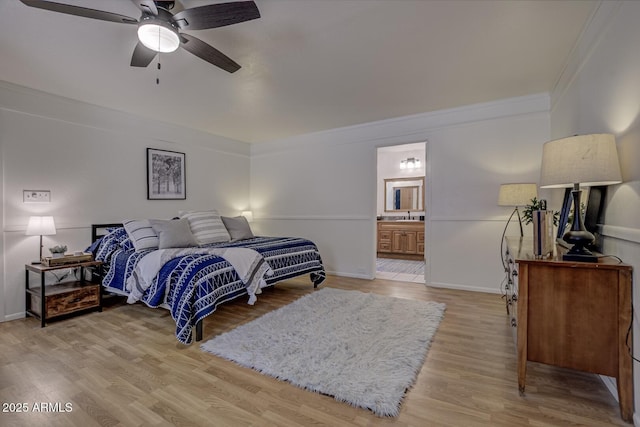 3440 N Meadow Dr, Pine, AZ 85544 - bedroom with ornamental molding, light wood finished floors, ensuite bath, baseboards, and a sink