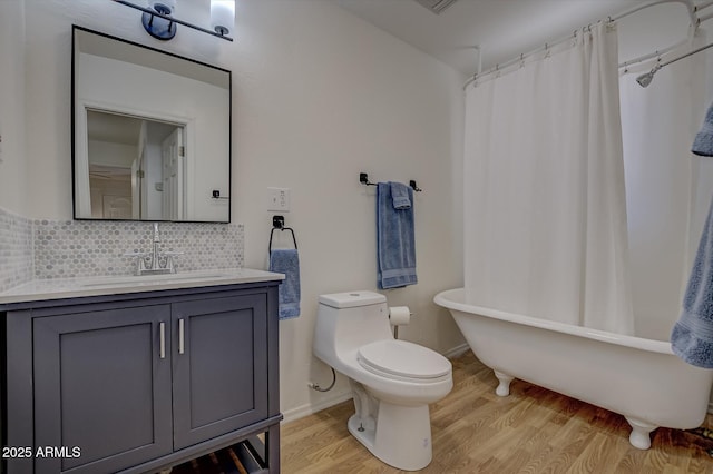 3440 N Meadow Dr, Pine, AZ 85544 - bathroom with wood finished floors, toilet, tasteful backsplash, a bath, and vanity