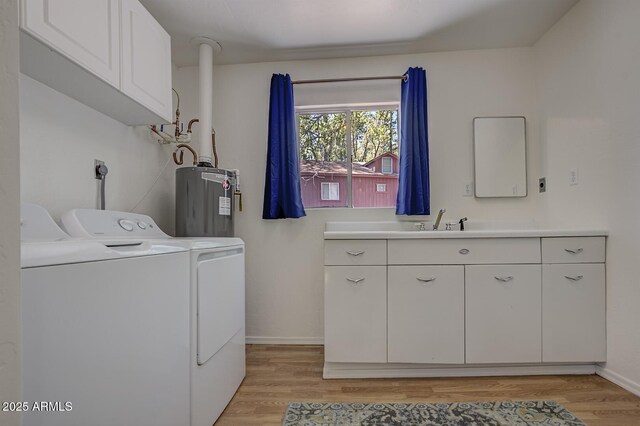 3440 N Meadow Dr, Pine, AZ 85544 - laundry area with washing machine and clothes dryer, water heater, baseboards, and light wood-style flooring