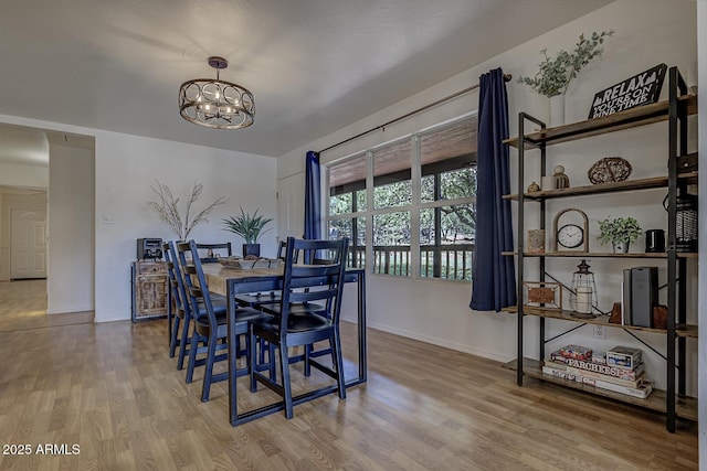 3440 N Meadow Dr, Pine, AZ 85544 - dining space featuring wood finished floors, a chandelier, and baseboards