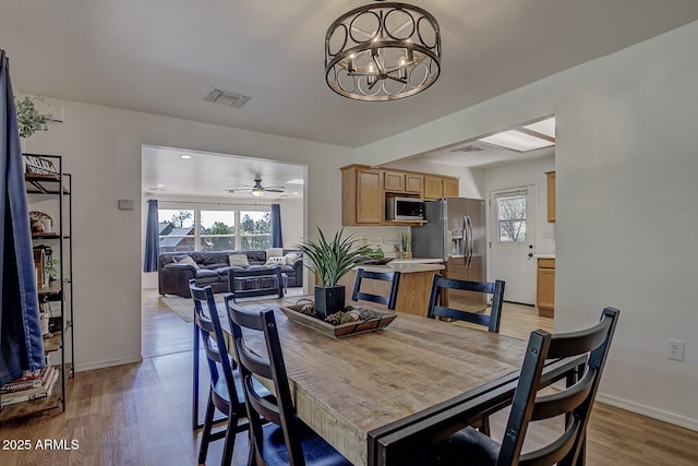 3440 N Meadow Dr, Pine, AZ 85544 - dining room with plenty of natural light, light wood-style floors, a chandelier, and baseboards