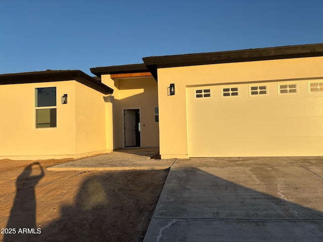 3627 W Palmaire Ave, Phoenix, AZ 85051 - view of front of house with stucco siding, concrete driveway, and an attached garage