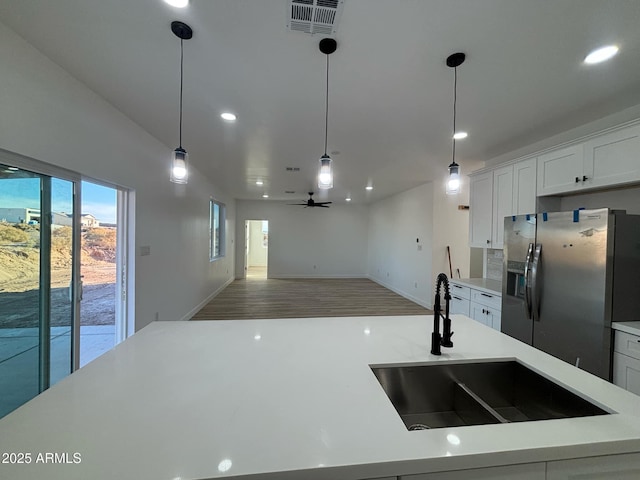 3627 W Palmaire Ave, Phoenix, AZ 85051 - kitchen featuring stainless steel refrigerator with ice dispenser, a sink, light countertops, recessed lighting, and pendant lighting
