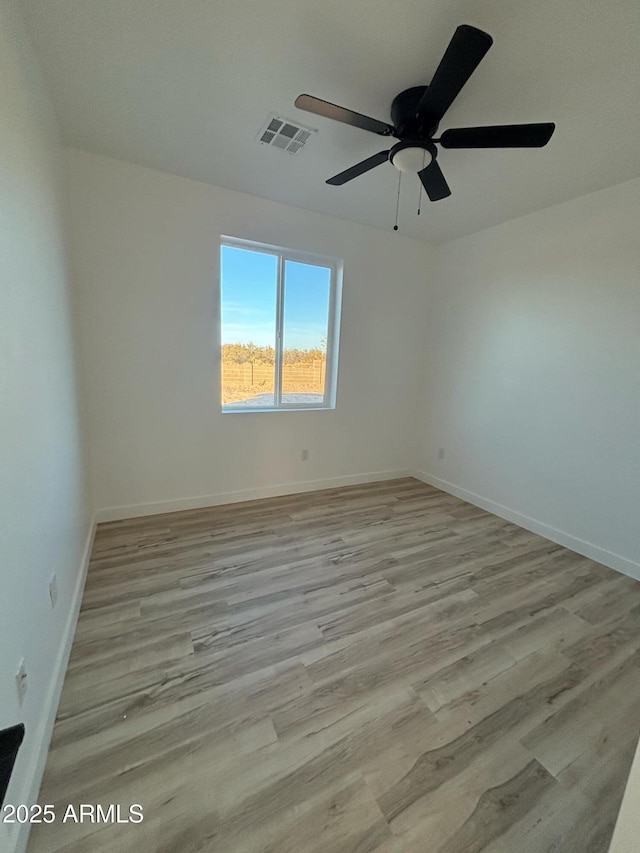 3627 W Palmaire Ave, Phoenix, AZ 85051 - spare room featuring wood finished floors, ceiling fan, and baseboards