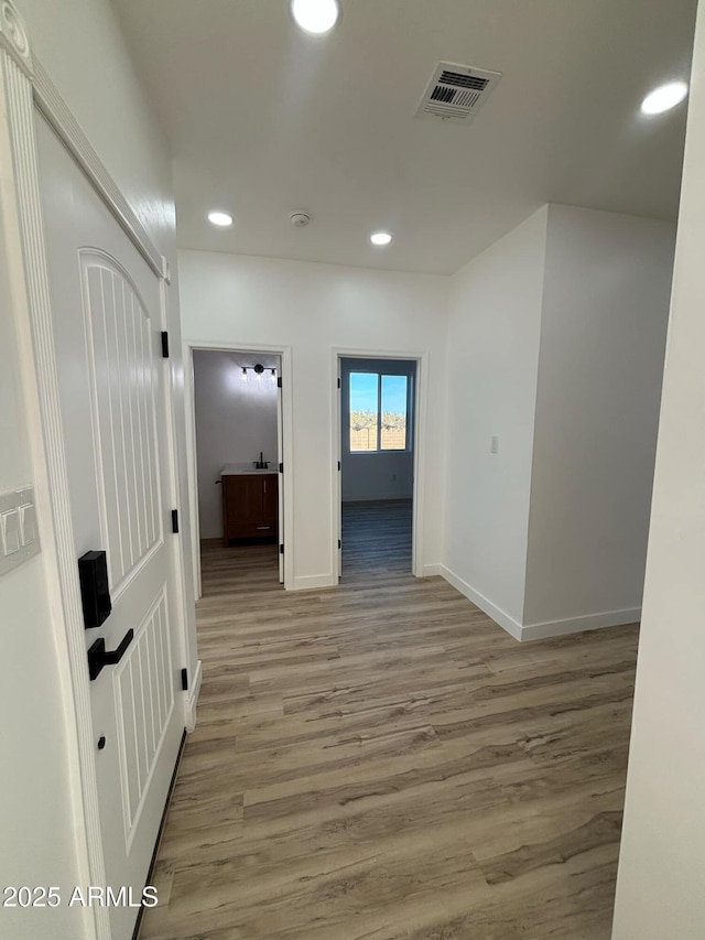 3627 W Palmaire Ave, Phoenix, AZ 85051 - hallway featuring recessed lighting, light wood finished floors, and baseboards
