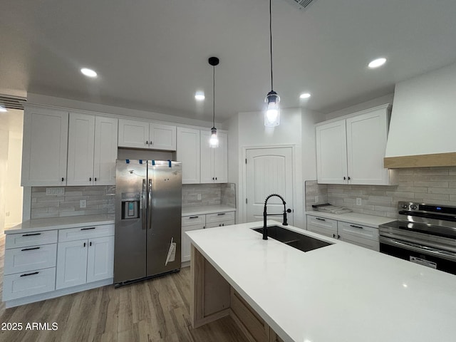 3627 W Palmaire Ave, Phoenix, AZ 85051 - kitchen featuring stainless steel appliances, a sink, decorative backsplash, white cabinetry, and recessed lighting