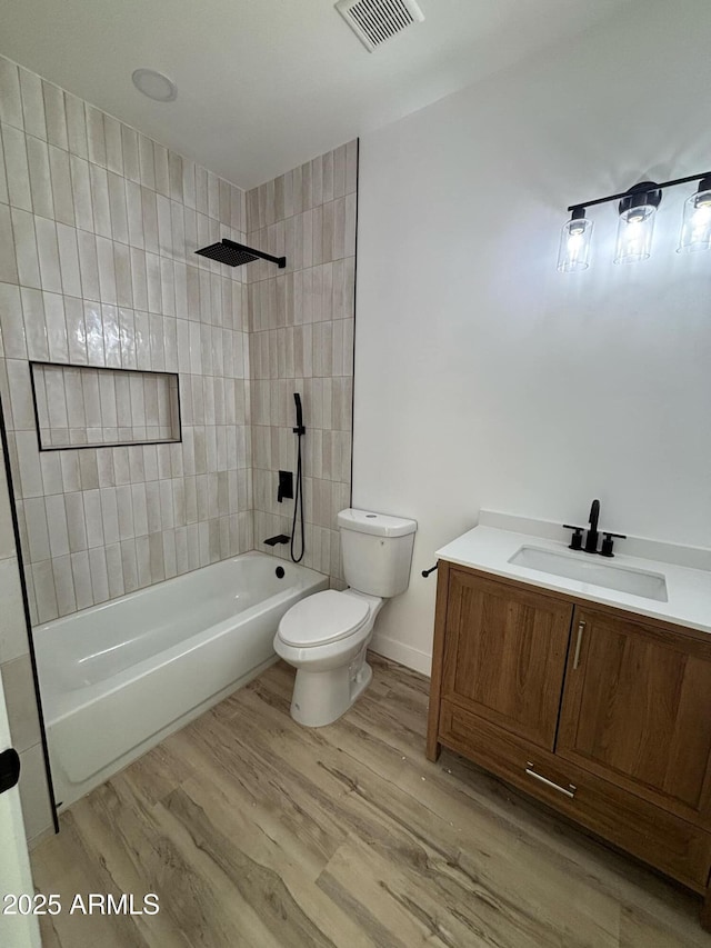 3627 W Palmaire Ave, Phoenix, AZ 85051 - bathroom featuring toilet, vanity, wood finished floors, and shower / bathtub combination