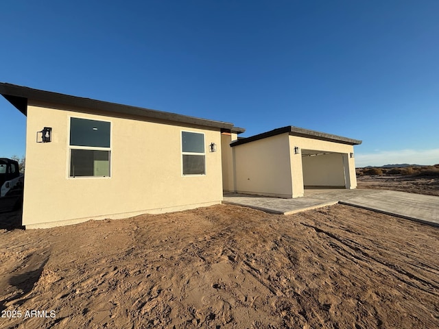 3627 W Palmaire Ave, Phoenix, AZ 85051 - view of side of home with stucco siding and a patio