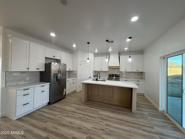 3627 W Palmaire Ave, Phoenix, AZ 85051 - kitchen with stainless steel appliances, backsplash, a sink, wood finished floors, and recessed lighting