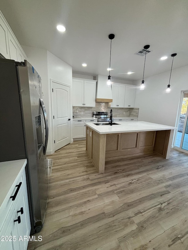 3627 W Palmaire Ave, Phoenix, AZ 85051 - kitchen featuring stainless steel appliances, light wood finished floors, a sink, backsplash, and recessed lighting