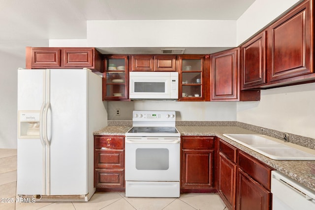 kitchen featuring sink, white appliances, and light tile patterned floors