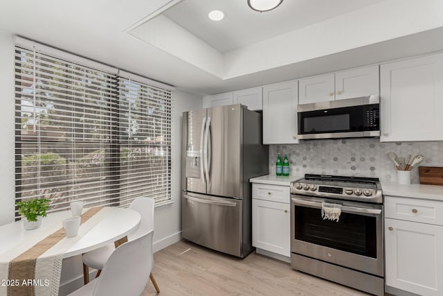 515 S Saguaro Way, Mesa, AZ 85208 - kitchen with stainless steel appliances, light countertops, white cabinets, and light wood-type flooring