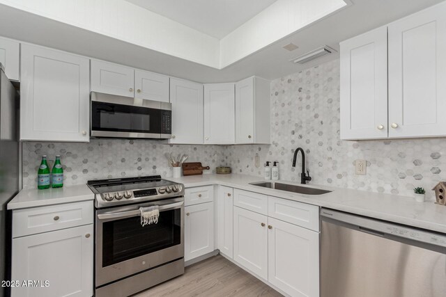 515 S Saguaro Way, Mesa, AZ 85208 - kitchen featuring stainless steel appliances, light countertops, and white cabinets