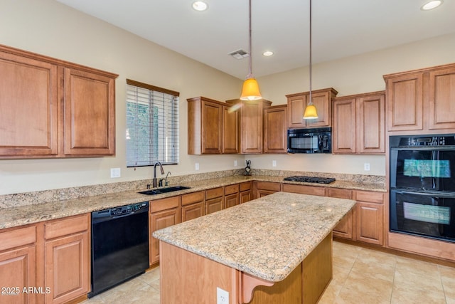 16758 W Apache St, Goodyear, AZ 85338 - kitchen with black appliances, a sink, a kitchen island, light stone counters, and recessed lighting