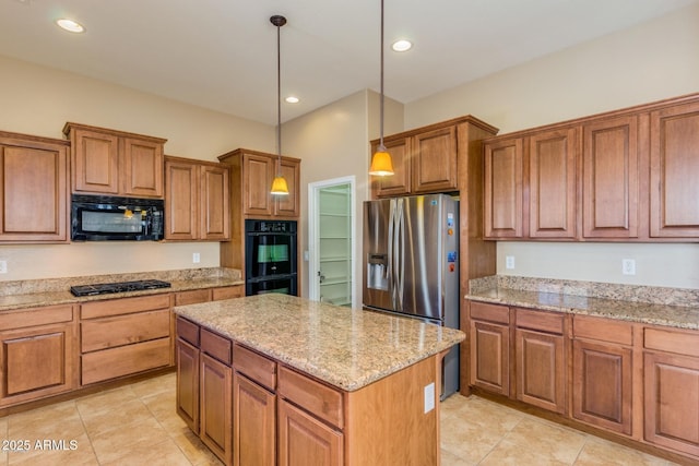 16758 W Apache St, Goodyear, AZ 85338 - kitchen featuring black appliances, brown cabinetry, a kitchen island, light stone countertops, and recessed lighting