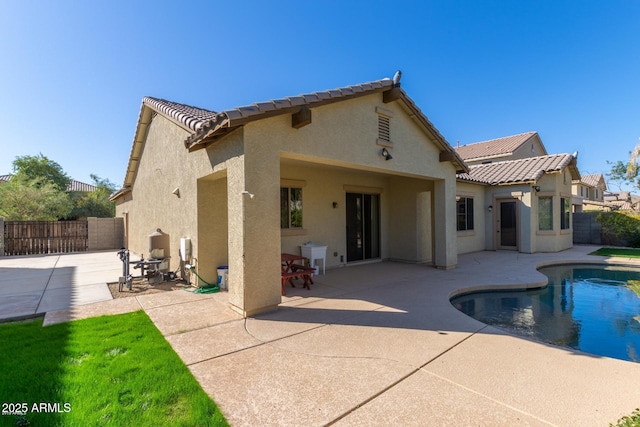 16758 W Apache St, Goodyear, AZ 85338 - rear view of house with stucco siding, a tiled roof, and a patio area