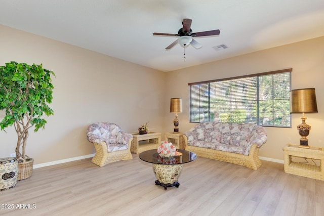 16758 W Apache St, Goodyear, AZ 85338 - living area featuring wood finished floors, baseboards, and a ceiling fan