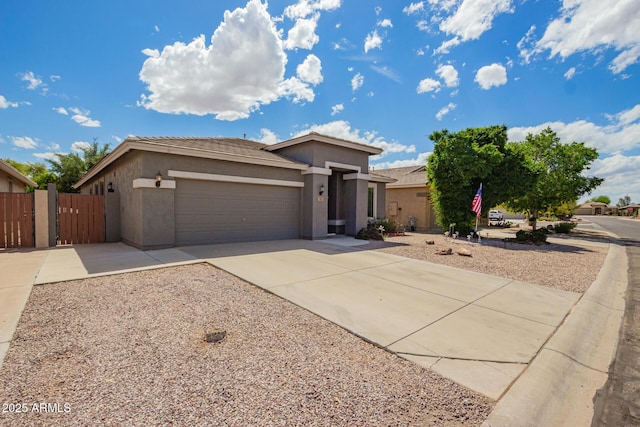 81 E Rock Wren Dr, San Tan Valley, AZ 85143 - view of front facade with stucco siding, an attached garage, concrete driveway, and a gate