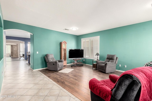 81 E Rock Wren Dr, San Tan Valley, AZ 85143 - living area featuring arched walkways, light tile patterned floors, and baseboards