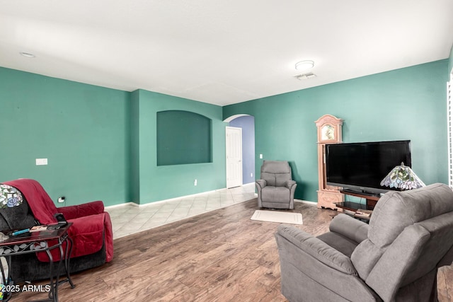 81 E Rock Wren Dr, San Tan Valley, AZ 85143 - living area featuring wood finished floors, arched walkways, and baseboards