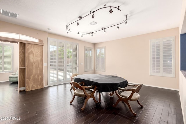 81 E Rock Wren Dr, San Tan Valley, AZ 85143 - dining space with baseboards, dark wood-type flooring, and rail lighting