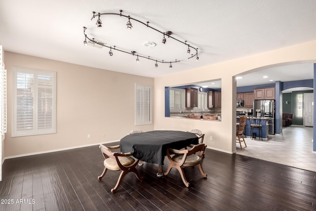 81 E Rock Wren Dr, San Tan Valley, AZ 85143 - dining room with arched walkways, baseboards, and wood finished floors