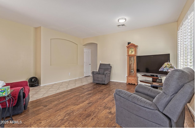81 E Rock Wren Dr, San Tan Valley, AZ 85143 - living room featuring arched walkways and wood finished floors