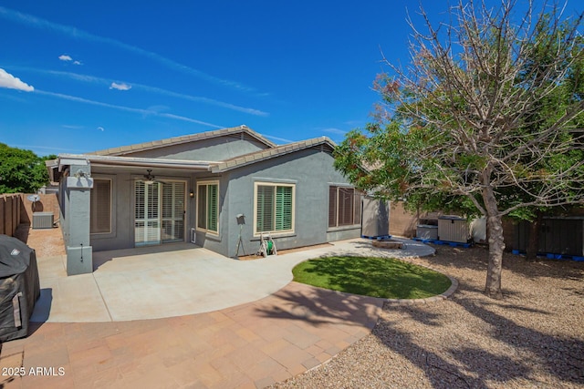 81 E Rock Wren Dr, San Tan Valley, AZ 85143 - back of property featuring stucco siding, a fenced backyard, ceiling fan, central AC, and a patio