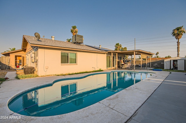 13802 N 37th Dr, Phoenix, AZ 85053 - view of swimming pool featuring a patio area, a storage unit, and a fenced backyard