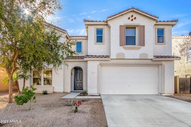 mediterranean / spanish-style home with a garage