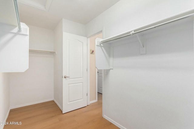 spacious closet featuring light hardwood / wood-style floors