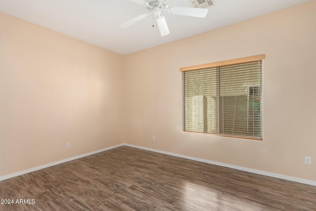 spare room featuring dark hardwood / wood-style floors and ceiling fan