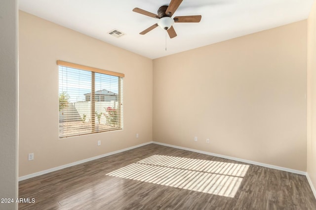 spare room with hardwood / wood-style floors and ceiling fan