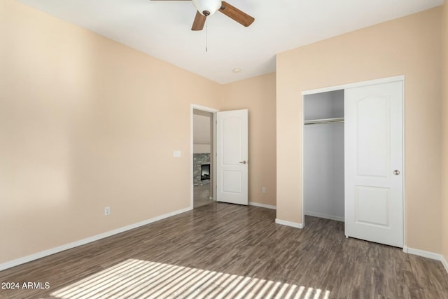 unfurnished bedroom featuring ceiling fan, dark hardwood / wood-style flooring, and a closet