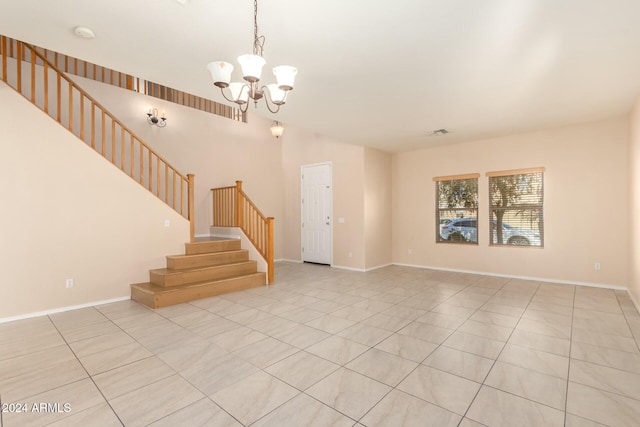 unfurnished living room with a chandelier and light tile patterned floors