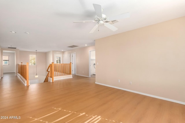 unfurnished room featuring hardwood / wood-style floors and ceiling fan