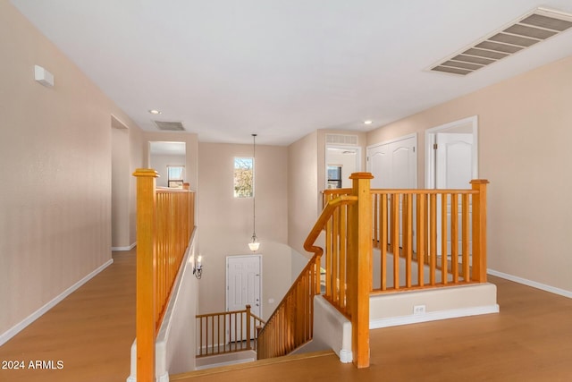 stairway with hardwood / wood-style floors