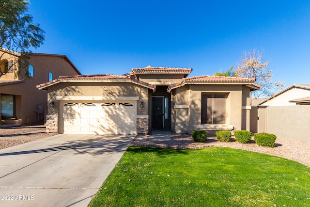 mediterranean / spanish home featuring a garage and a front yard