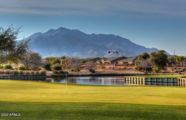 view of community featuring a yard and a water and mountain view