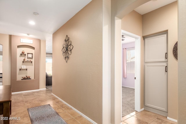 corridor with light tile patterned floors