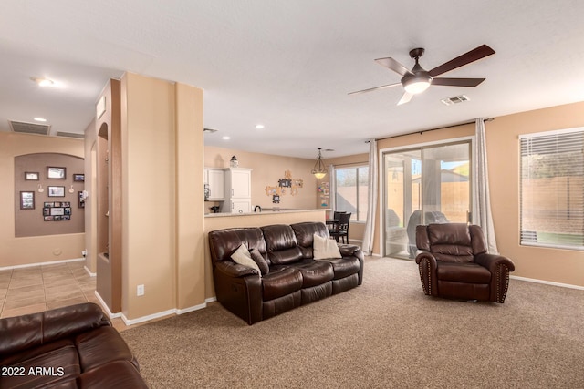 living room with light colored carpet and ceiling fan