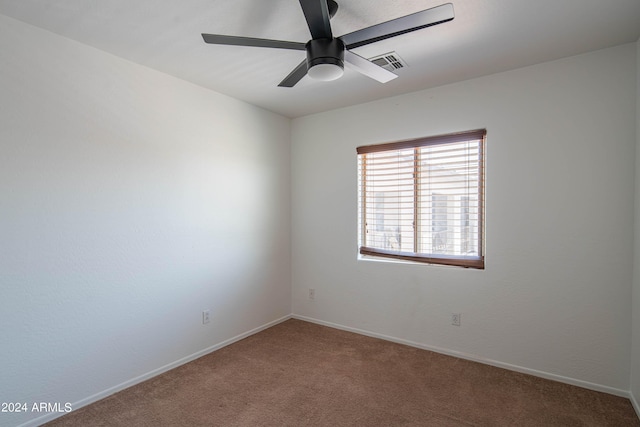 carpeted empty room featuring ceiling fan