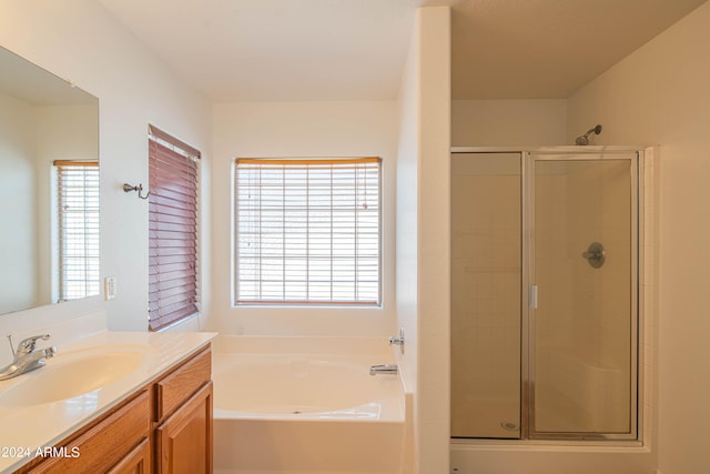 bathroom featuring vanity and plus walk in shower