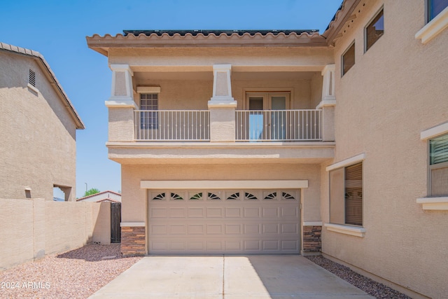 view of front facade with a balcony and a garage