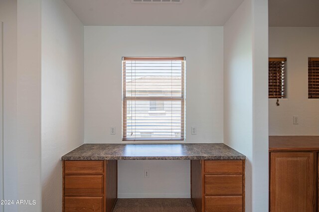 kitchen featuring plenty of natural light and built in desk