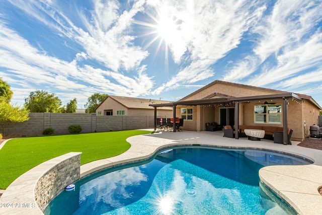 view of pool with a patio and a lawn