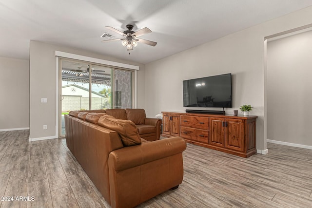 living room featuring ceiling fan and light hardwood / wood-style flooring