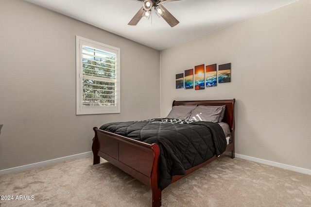 bedroom featuring light carpet and ceiling fan