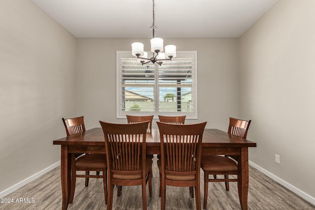 dining space with a chandelier and hardwood / wood-style floors